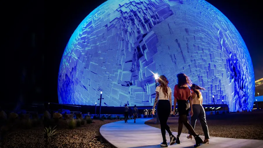 Sphere in Las Vegas, illuminated blue at night.