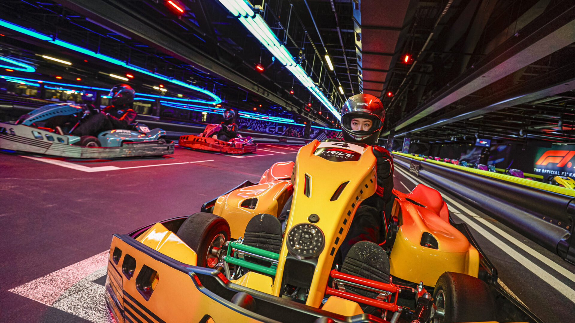 Visitors racing at F1 DRIVE the Immersive brand destination blending race data, design, and experience.