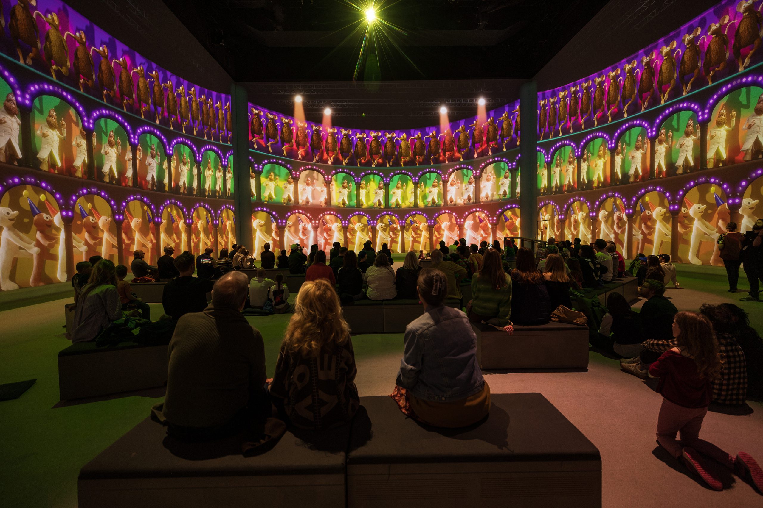 Families watch tiers of glowing arches filled with Aardman characters wrap around Lightroom