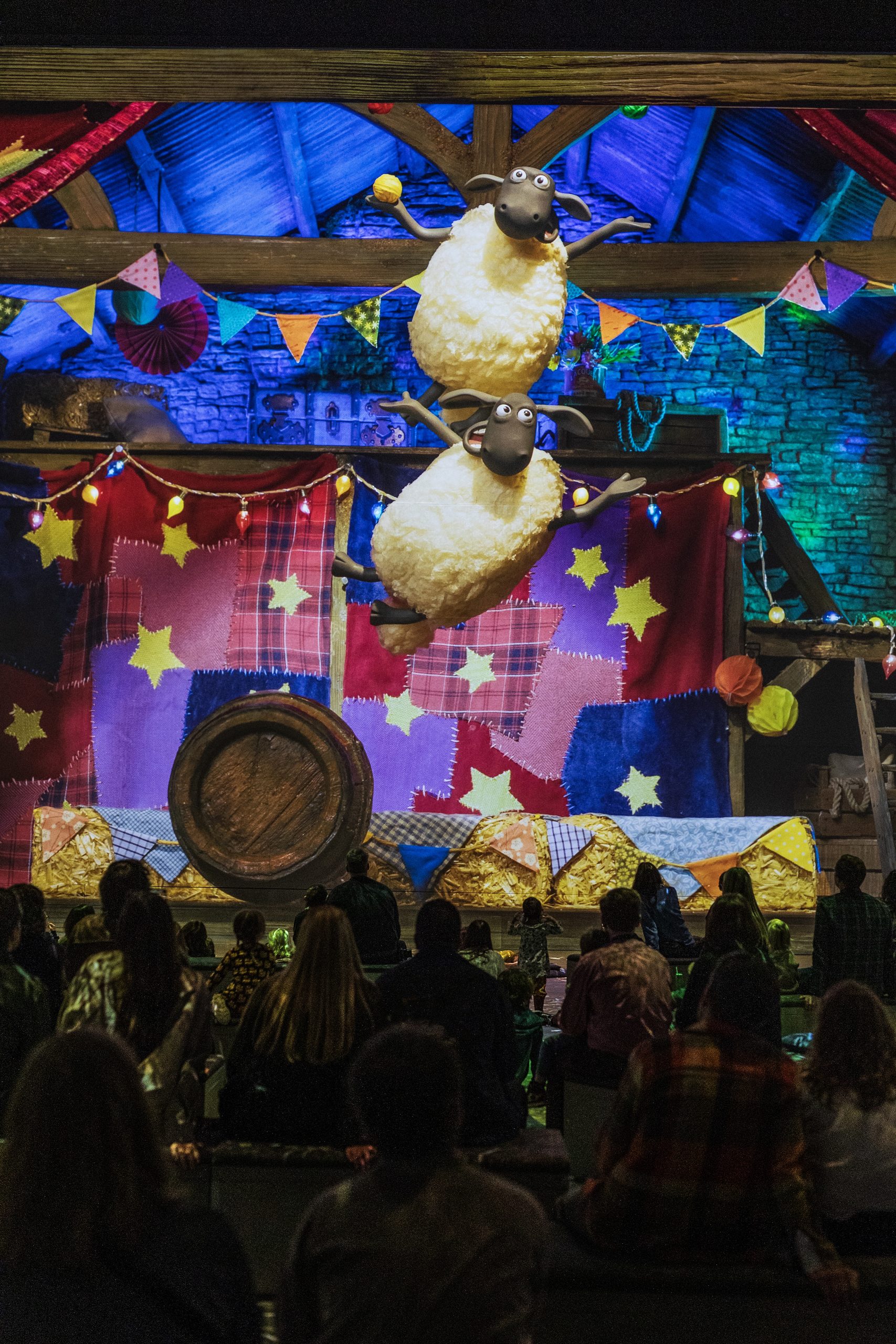 Shaun the Sheep and the flock leap across a projected barn above audiences at Lightroom