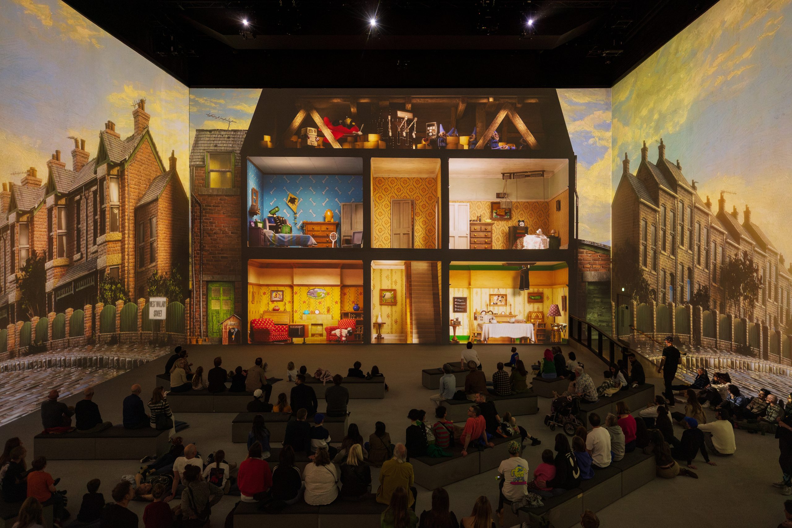 Audiences watch a cutaway of Wallace & Gromit’s terraced house projected across Lightroom’s walls