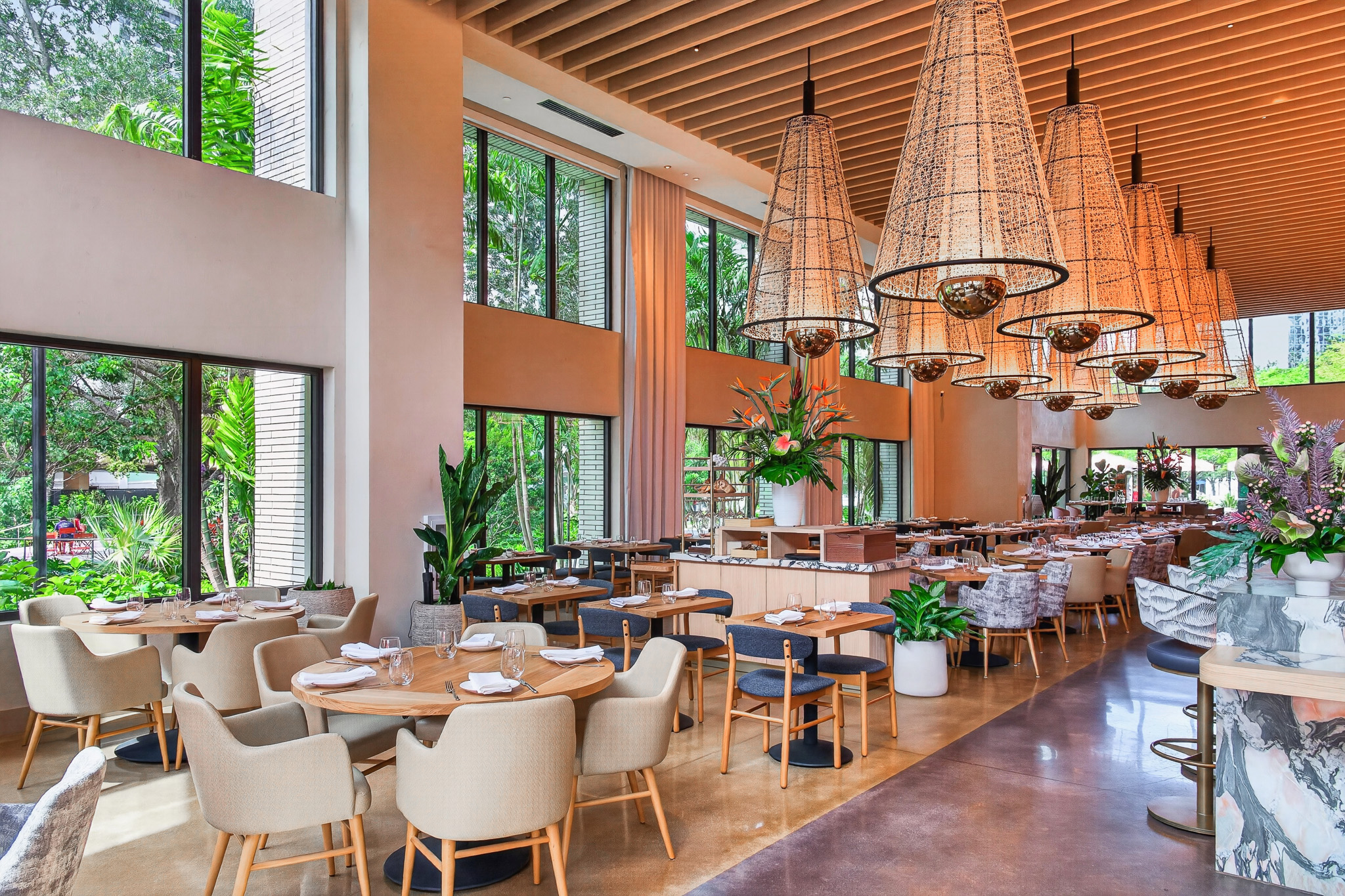 The restaurant's dining room, with nearly 20-foot windows looking out to the greenery of Huizenga Park